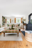 Bright living room with tiled stove and chequered coffee table