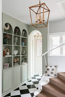 Elegant entrance area with decorative elements and marble tiles in a chequerboard pattern