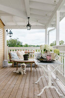 Cosy veranda with wooden floorboards, seating area and lanterns