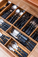 Cutlery with black handle in cutlery drawer