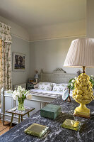 Classic bedroom with floral decor and marble chest of drawers with jewellery box