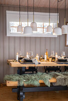 Dining area with wooden bench, cosy furs and Scandinavian table decorations