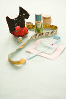 Sewing kit with dog-shaped pincushion, tape measure and spools of thread