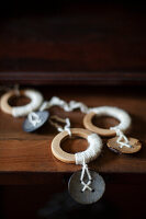 Handmade pendants made from wooden rings and buttons wrapped in yarn