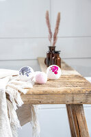 Natural wooden table with handmade bath bombs in the bathroom