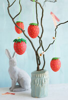 Easter branch with strawberry Easter eggs and bunny figurine