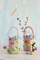 Colourful DIY Easter baskets made from tetrapak with pompoms and chenille wire