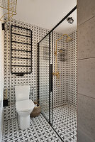 Bathroom with patterned tiles and glass shower