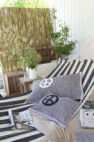 Homemade cushions with a peace sign on a striped hammock