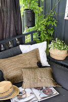 DIY cushions made from fringed rugs on an outdoor sofa in the garden