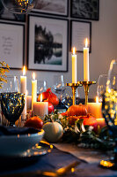 Festive table setting with pumpkins and candles