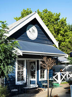 Blue café house with terrace and outdoor seating area