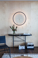 Modern entrance area with floating wall lamp and black console table
