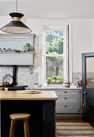 Traditional kitchen with light grey cabinets and wall tiles