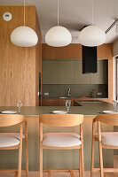 Modern kitchen with wood panelling and hanging ball lights