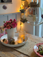 White tray with autumnal table decoration on a wooden table