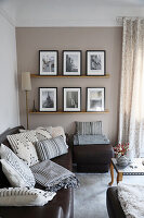 Living room with brown leather sofa, black and white patterned cushions and picture wall