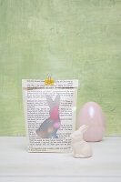 Easter bag made from book pages with transparent bunny silhouette and Easter decoration