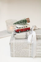 Gift in newspaper with small VW bus and Christmas tree