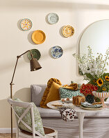 Dining area with decorative wall plates and bouquet of sunflowers