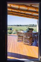 Covered terrace area with rattan chairs and views of the countryside