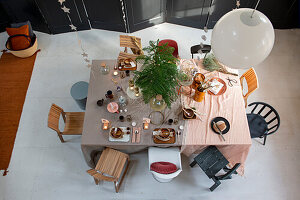 Dining area decorated with different wooden chairs for Christmas celebrations