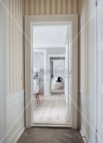 View From Narrow Hallway With Striped Wallpaper And Herringbone View From Narrow Hallway With Striped Wallpaper And Herringbone Parquet Into Living Area Rustic Wooden Floor