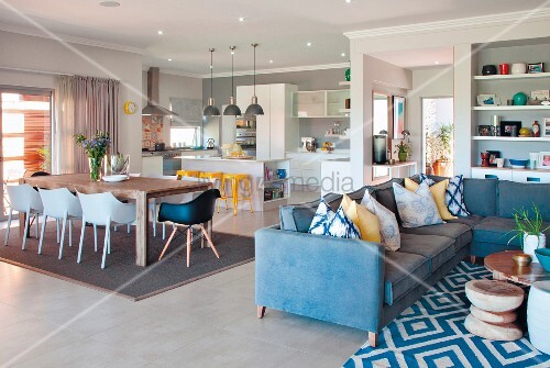Blue Corner Sofa With Ter Cushions And Patterned Rug In Front Of Blue Corner Sofa With Ter Cushions And Patterned Rug In Front Of Dining Area S Chairs Open Plan Kitchen