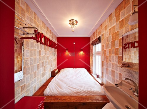 Bed Against Bright Red Wall And Designer Buy Image