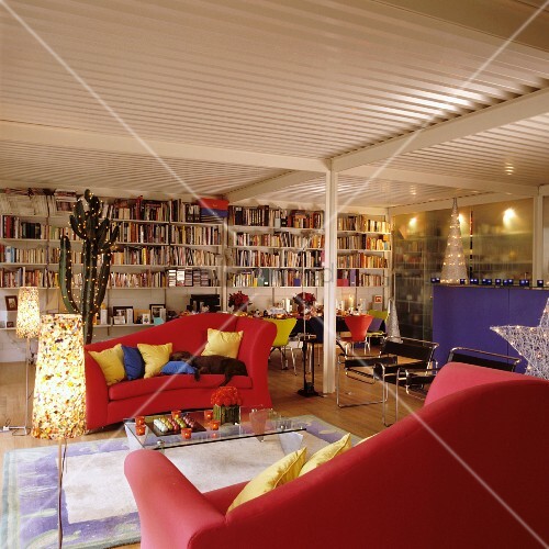 Red Sofas And Full Bookcase In Festively Buy Image