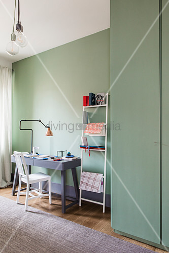 Desk next to stationary on metal ladder \u2026 \u2013 Buy image
