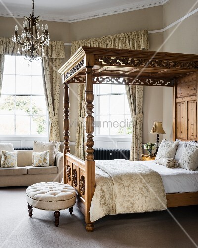 Ornate Four Poster Bed With Scatter Cushions In Bedroom With