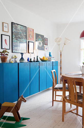 Candles And Ornaments On Blue Sideboard Buy Image