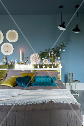 Velvet scatter cushions on double bed in festively decorated bedroom