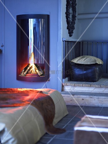 Wood Burning Stove With Fire In A Country Style Bedroom